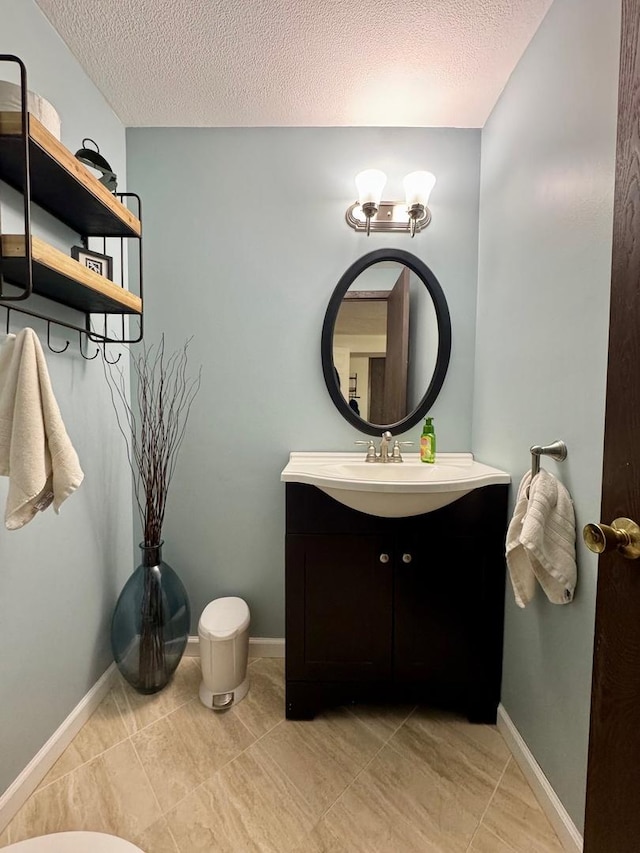 660 Londonberry Ln, Bolingbrook, IL 60440 - bathroom featuring vanity, a textured ceiling, tile patterned floors, and baseboards