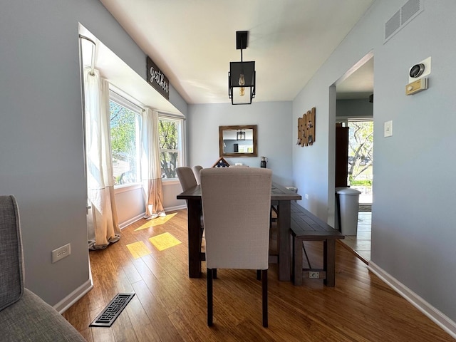 660 Londonberry Ln, Bolingbrook, IL 60440 - dining room featuring wood finished floors, healthy amount of natural light, and baseboards