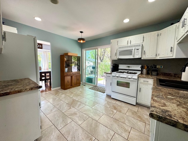 660 Londonberry Ln, Bolingbrook, IL 60440 - kitchen featuring white appliances, a sink, dark countertops, plenty of natural light, and recessed lighting