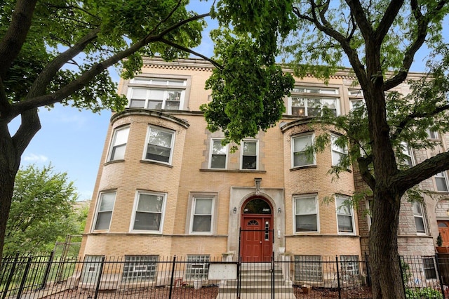 view of front facade featuring a fenced front yard and brick siding