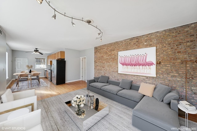 4736 S Saint Lawrence Ave Unit 1S, Chicago, IL 60615 - living room featuring light wood finished floors, ceiling fan, brick wall, and rail lighting