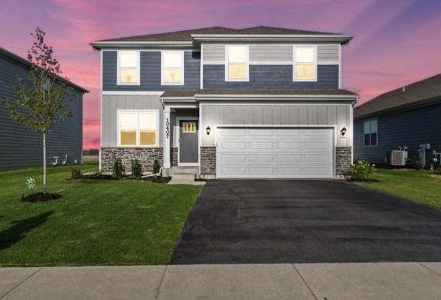 10407 Morse Pl, Crown Point, IN 46307 - traditional-style house featuring board and batten siding, driveway, a garage, a front lawn, and stone siding