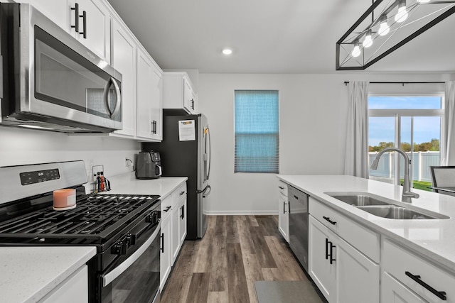 10407 Morse Pl, Crown Point, IN 46307 - kitchen with appliances with stainless steel finishes, a sink, recessed lighting, white cabinetry, and dark wood-type flooring