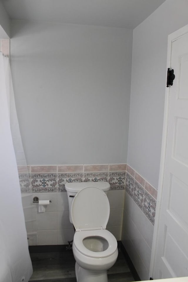 detailed view of baseboards, a fireplace, and wood finished floors