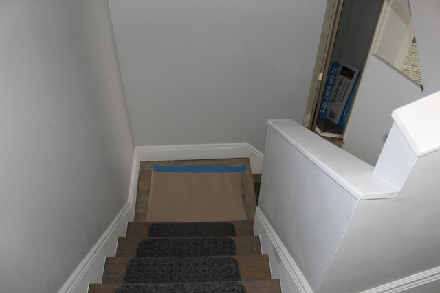 stairway featuring wood finished floors