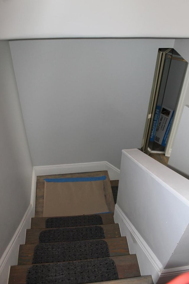 stairway featuring baseboards