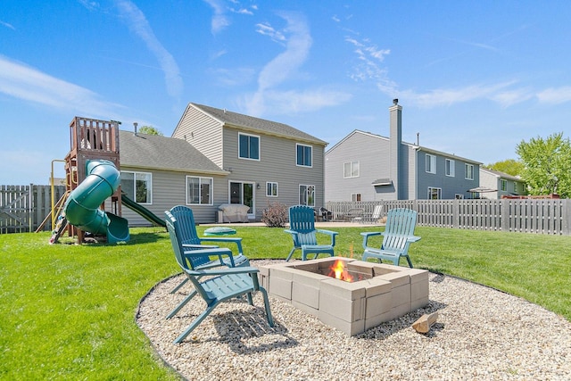 10134 Ashley St, Huntley, IL 60142 - back of house with an outdoor fire pit and a playground