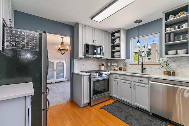 10134 Ashley St, Huntley, IL 60142 - kitchen with appliances with stainless steel finishes, open shelves, a sink, gray cabinets, and light countertops