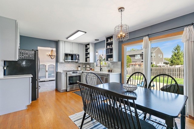 10134 Ashley St, Huntley, IL 60142 - dining room featuring a chandelier and light wood-style flooring