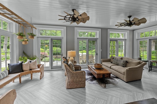 sunroom with french doors and a deck