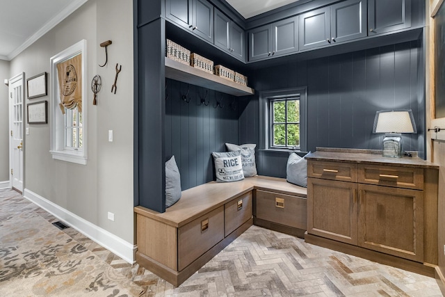 mudroom featuring baseboards and crown molding