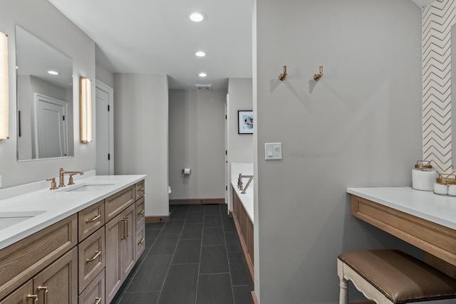 full bath with a sink, toilet, recessed lighting, double vanity, and baseboards
