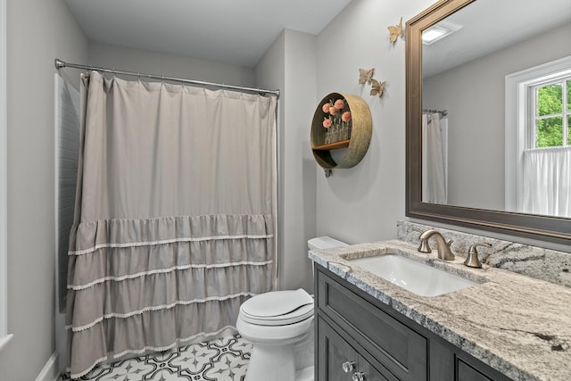 bathroom with toilet, curtained shower, and vanity