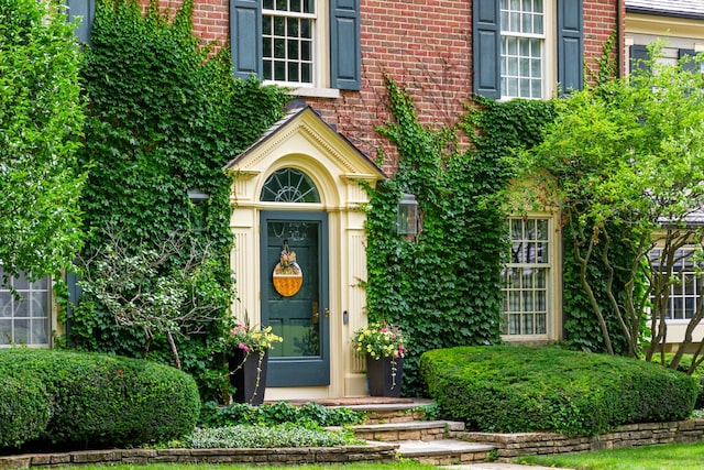 property entrance featuring brick siding
