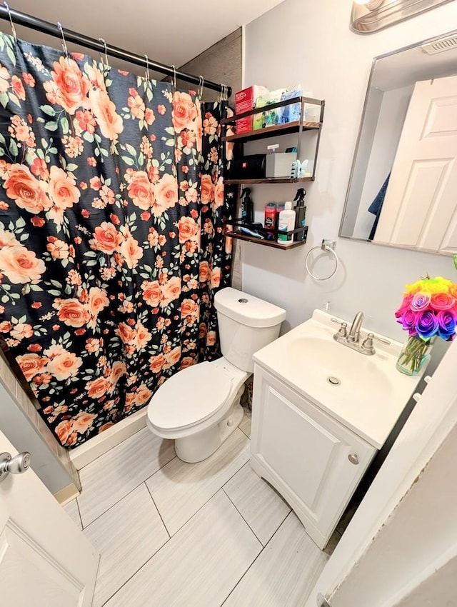 full bath featuring a shower with curtain, tile patterned flooring, vanity, and toilet