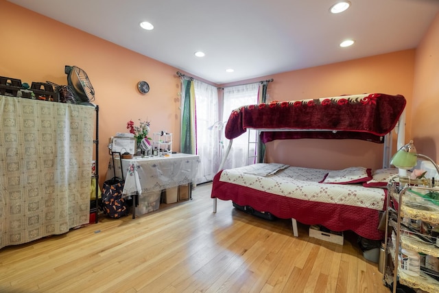 bedroom with recessed lighting and wood finished floors