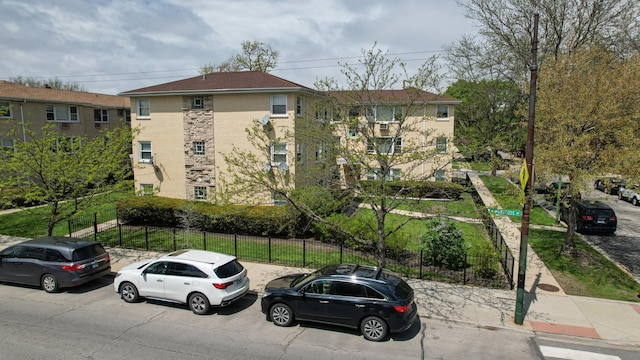 view of building exterior with fence