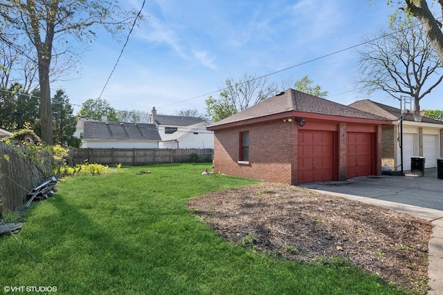 view of yard featuring a garage and fence