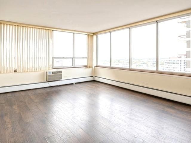 unfurnished sunroom with an AC wall unit