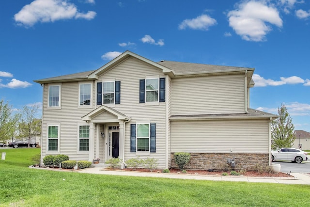 view of front of house with a front yard and stone siding