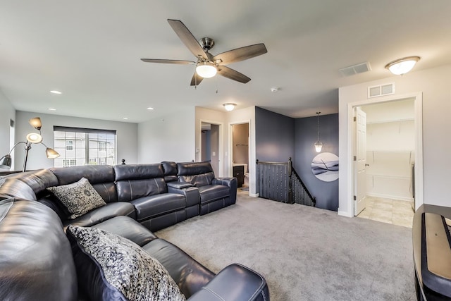 living room featuring light carpet, a ceiling fan, and baseboards