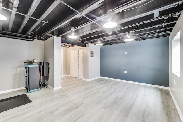 finished basement with wood finished floors and baseboards