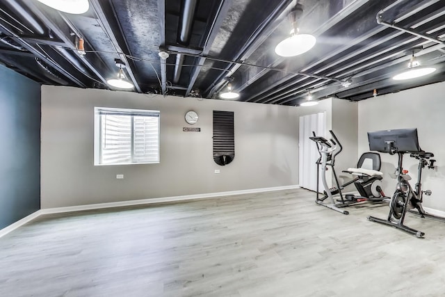 exercise room featuring wood finished floors and baseboards
