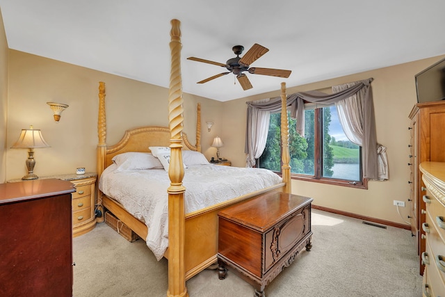 bedroom with a ceiling fan, baseboards, light colored carpet, and visible vents