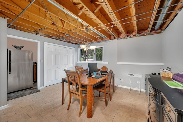 dining area featuring baseboards and light tile patterned flooring