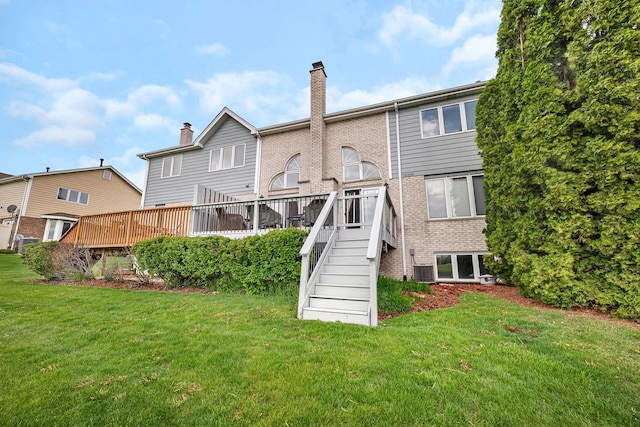 back of house with a lawn, stairs, and a chimney