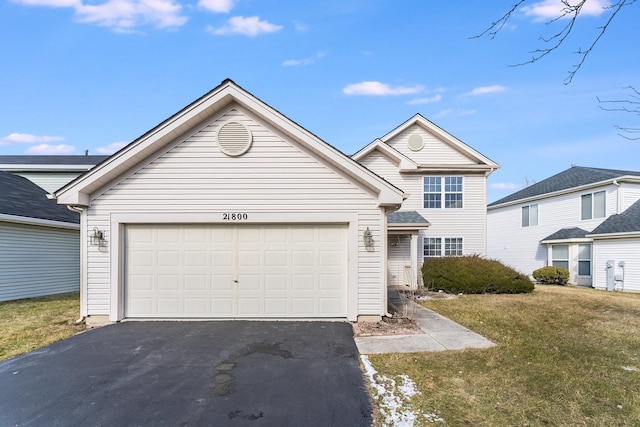 traditional home with a garage, a front lawn, and driveway