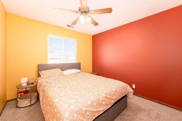 bedroom featuring visible vents, a ceiling fan, baseboards, and carpet floors