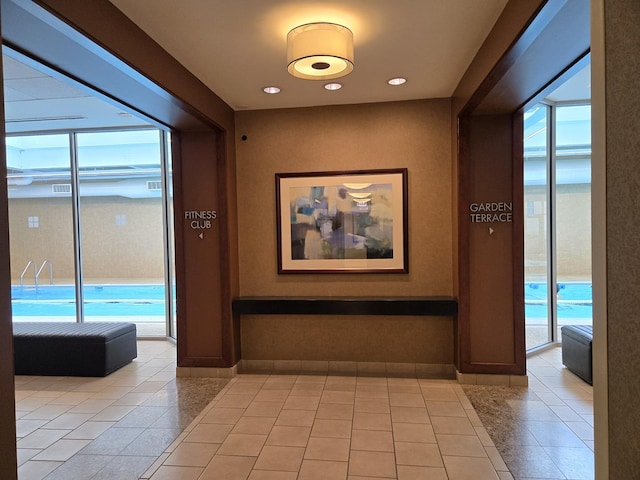 corridor with recessed lighting, baseboards, and tile patterned floors