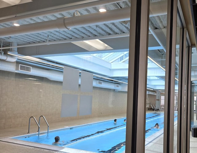 view of pool featuring a skylight