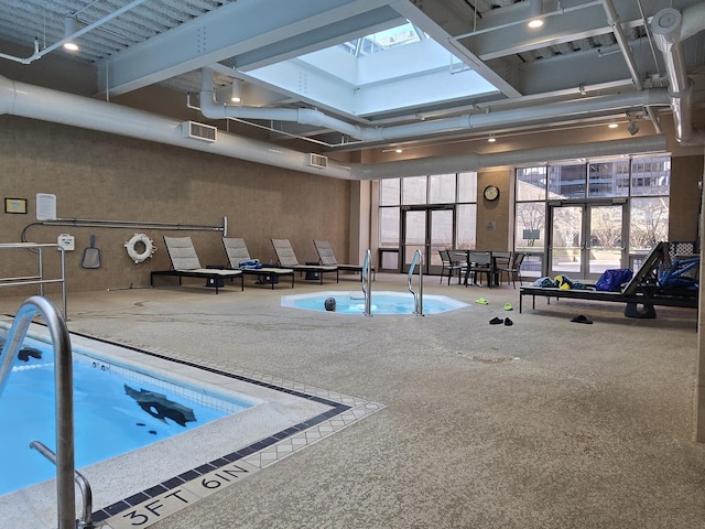 view of swimming pool featuring a skylight