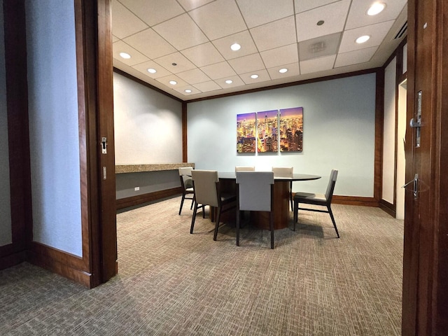 carpeted dining area featuring baseboards, a drop ceiling, and recessed lighting