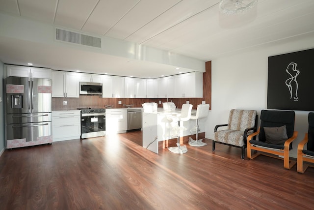 2900 Maple Ave Unit 19E, Downers Grove, IL 60515 - kitchen with white cabinetry, appliances with stainless steel finishes, dark wood-style floors, and visible vents