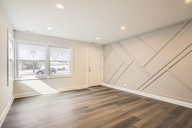 unfurnished room with recessed lighting, baseboards, dark wood finished floors, and visible vents