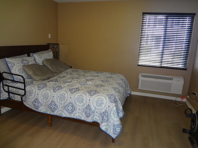 2013 Silverstone Dr Unit 2013, Carpentersville, IL 60110 - bedroom featuring baseboards, a wall mounted air conditioner, and wood finished floors