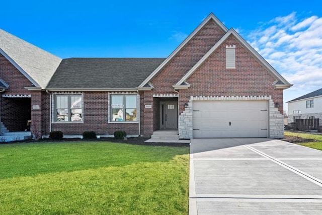 view of front facade featuring brick siding, a shingled roof, a front lawn, and concrete driveway