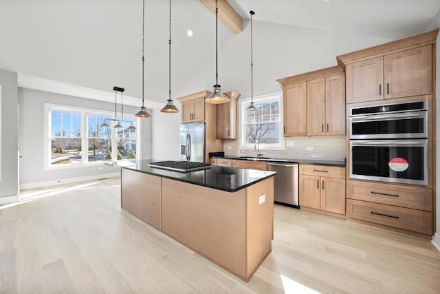 kitchen with light brown cabinetry, beamed ceiling, stainless steel appliances, and light wood-style flooring