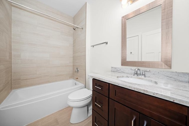 full bathroom with vanity, wood finished floors, toilet, and bathing tub / shower combination