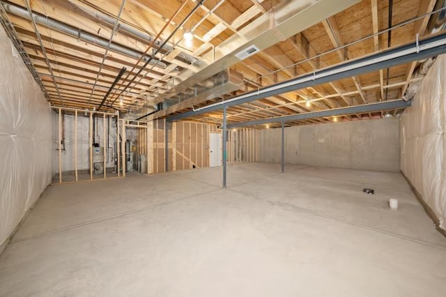 unfinished below grade area with visible vents and water heater