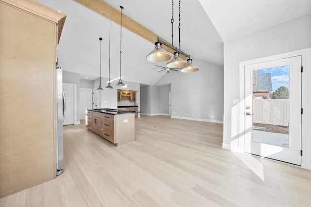kitchen with dark countertops, hanging light fixtures, light wood-type flooring, open floor plan, and vaulted ceiling with beams