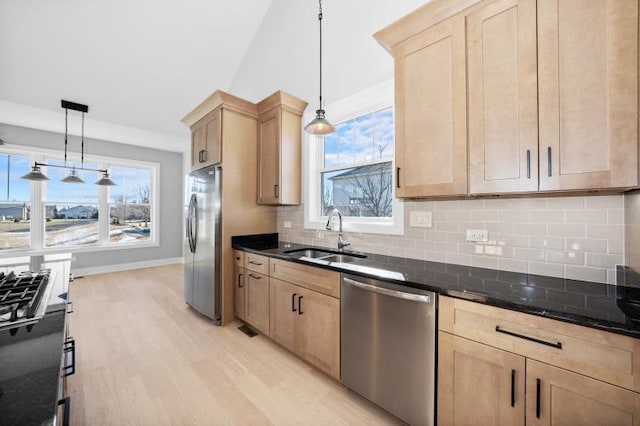 kitchen featuring a sink, light brown cabinets, decorative backsplash, and stainless steel appliances