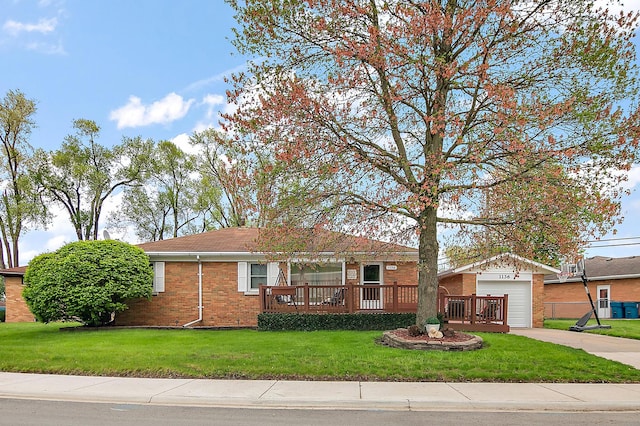 ranch-style house featuring a front yard, a garage, brick siding, an outdoor structure, and concrete driveway