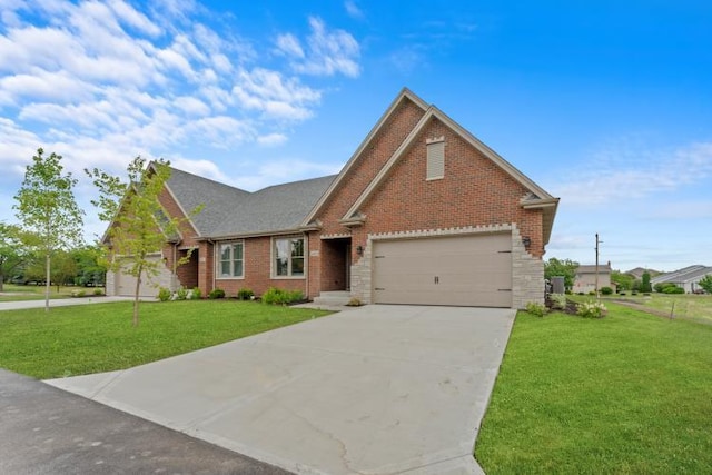 view of front of house with an attached garage, a front lawn, stone siding, brick siding, and driveway
