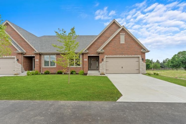 ranch-style home with brick siding, a garage, a front lawn, and concrete driveway