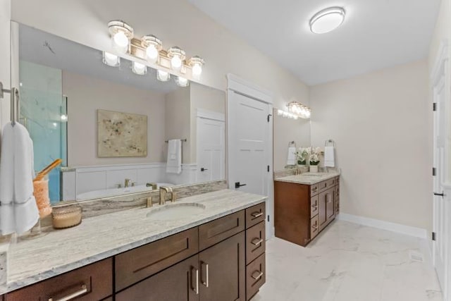 full bathroom featuring a sink, marble finish floor, two vanities, and a shower stall