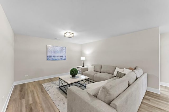 living room featuring light wood-style floors and baseboards